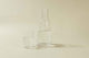 Clear drinking glass filled with water and clear glass water carafe filled with water