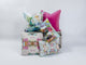 Grouping of Laura Park designed throw pillows featuring three square pillows and two oblong lumbar pillows; four pillows feature a multi-color abstract paint design and one is made of hot pink velvet