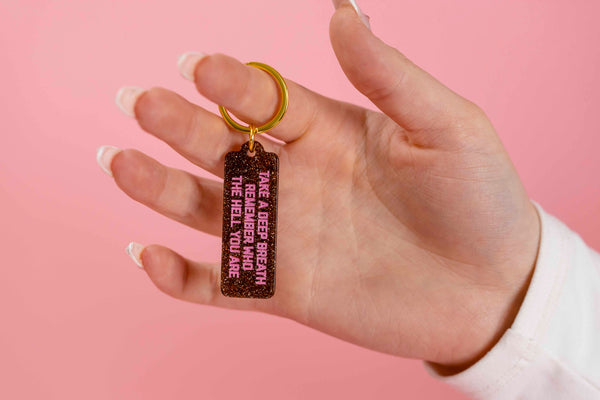 Plastic bronze rectangle keychain with gold and copper glitter with pink phrase Take A Deep Breath And Remember Who The Hell You Are, made by Golden Gems